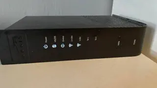 Router Arris TG2492 z przyciskiem WPS. Wskaźniki sygnalizują zasilanie, połączenie, pasma 2.4 GHz i 5 GHz, a także linie telefoniczne.